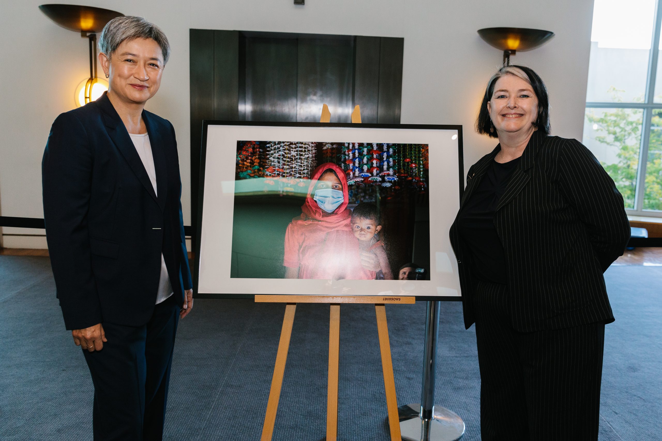Foreign Minister Penny Wong stands with Lyn Morgain, ACFID Board Member and Chief Executive at Oxfam Australia at a Parliamentary event on COVID19 aid
