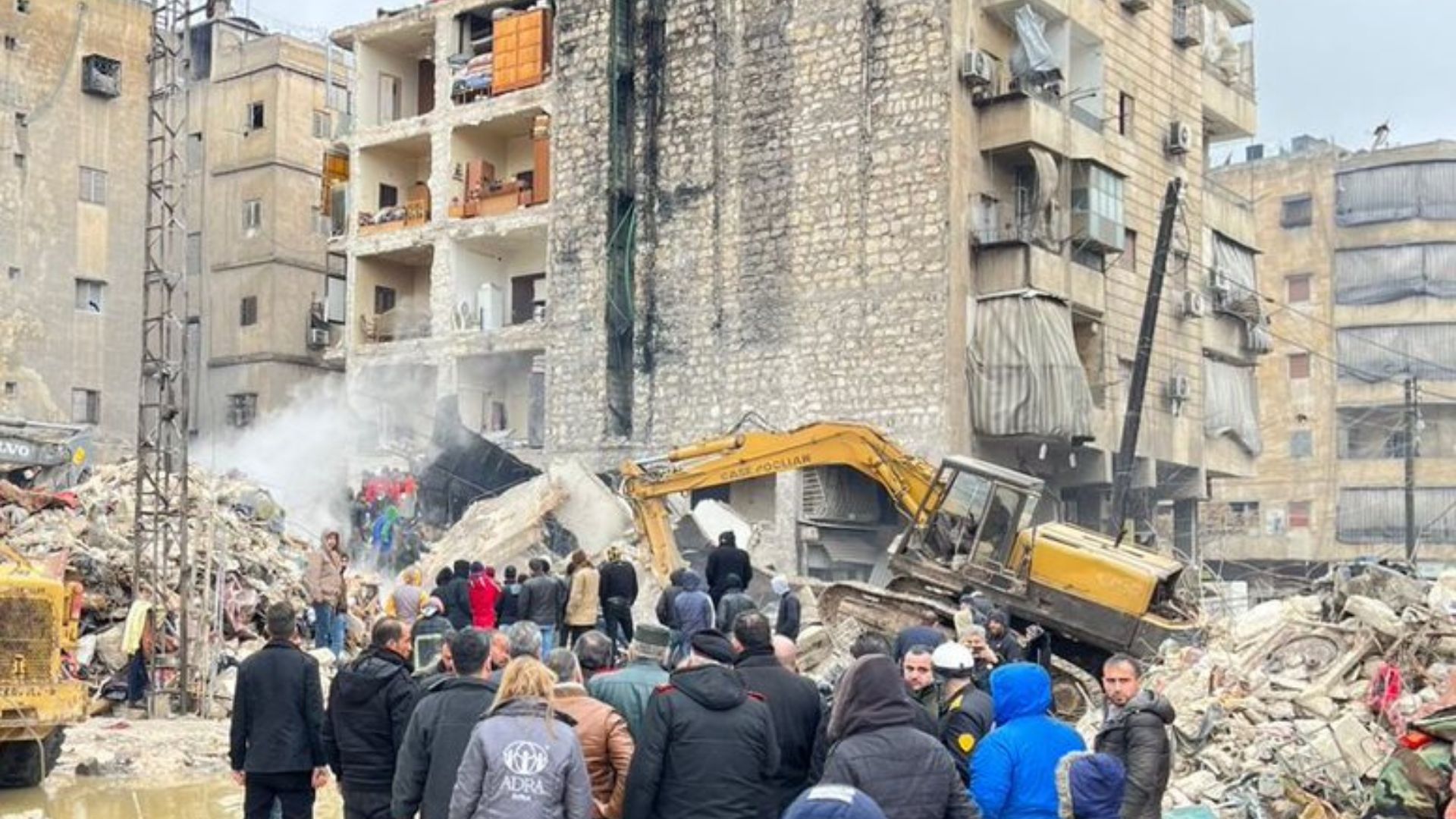 Buildings collapse after the wake of an earthquake in Turkiye and Syria. Aid workers are assisting in the cleanup
